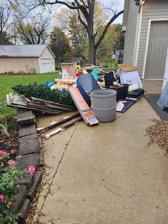 Dumpster being loaded with debris for Roofing Dumpster Rental in Fairview